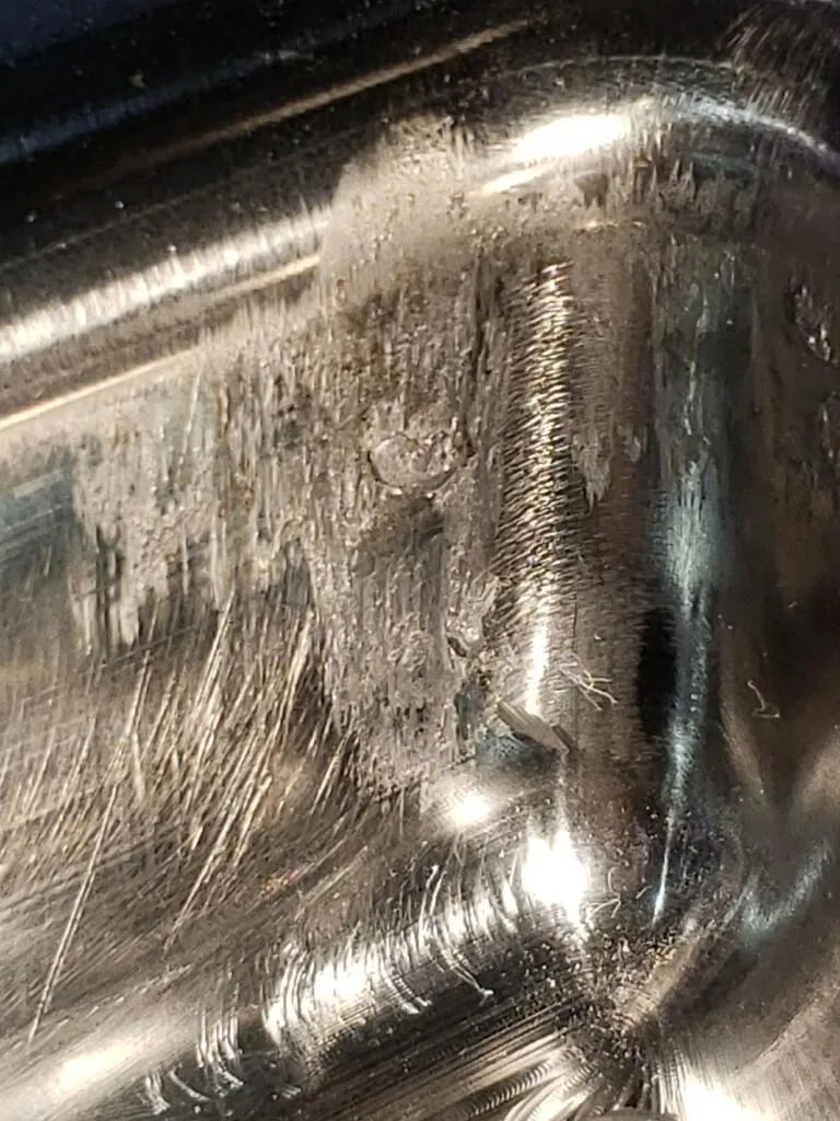 Metal pickup and scoring from galling on an uncoated forming die surface