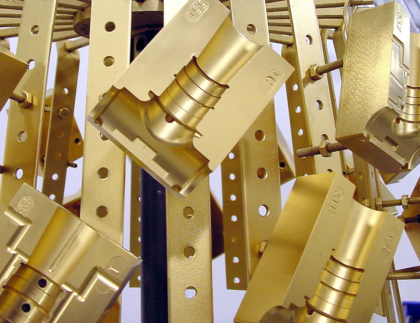 TiN-coated injection mold components on a coating fixture